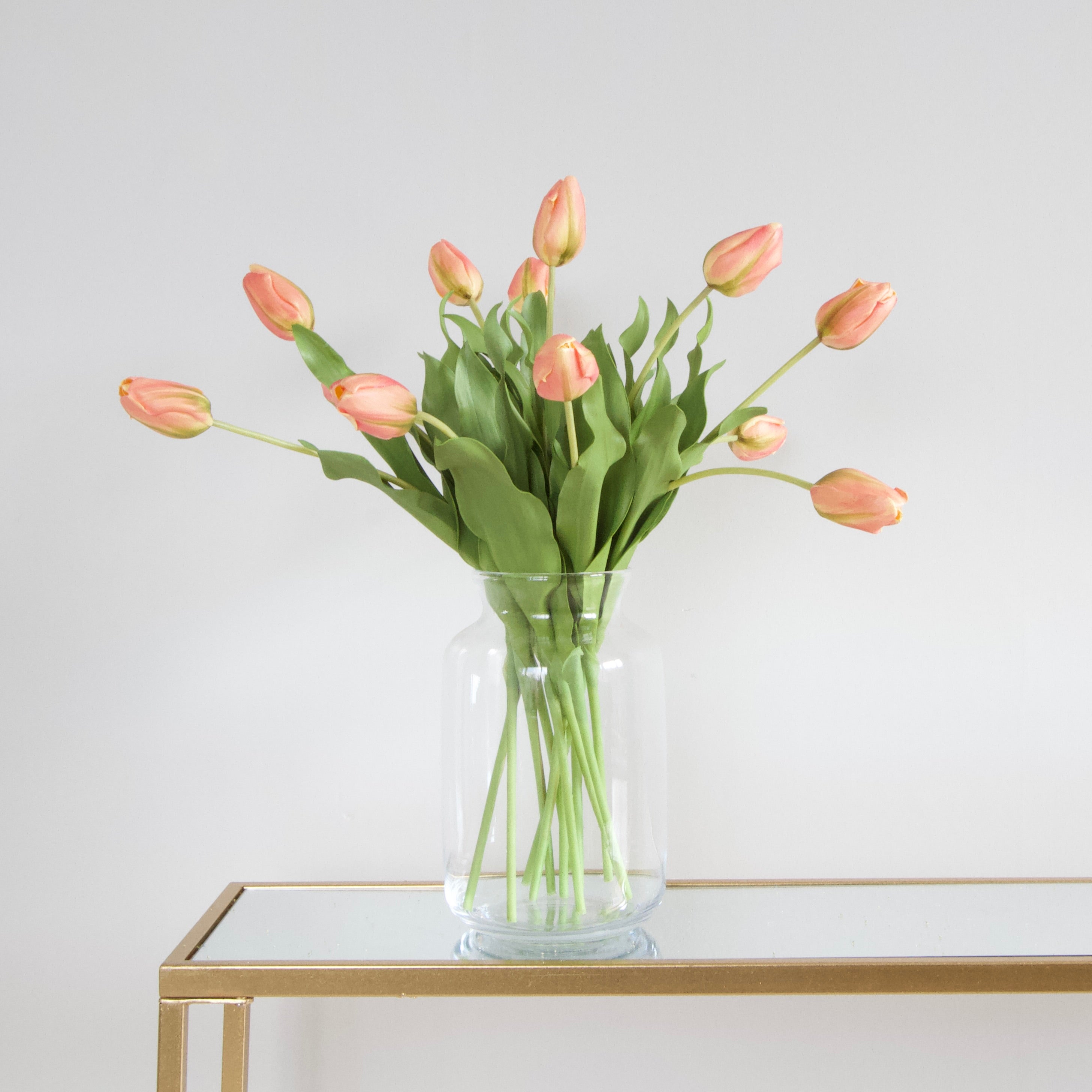 Luxury Lifelike Realistic Artificial Fabric Silk Blooms with Foliage Buy Online from The Faux Flower Company | 12 stems Orange Tulip ABY5657OR styled in Glass Funnel Neck Vase